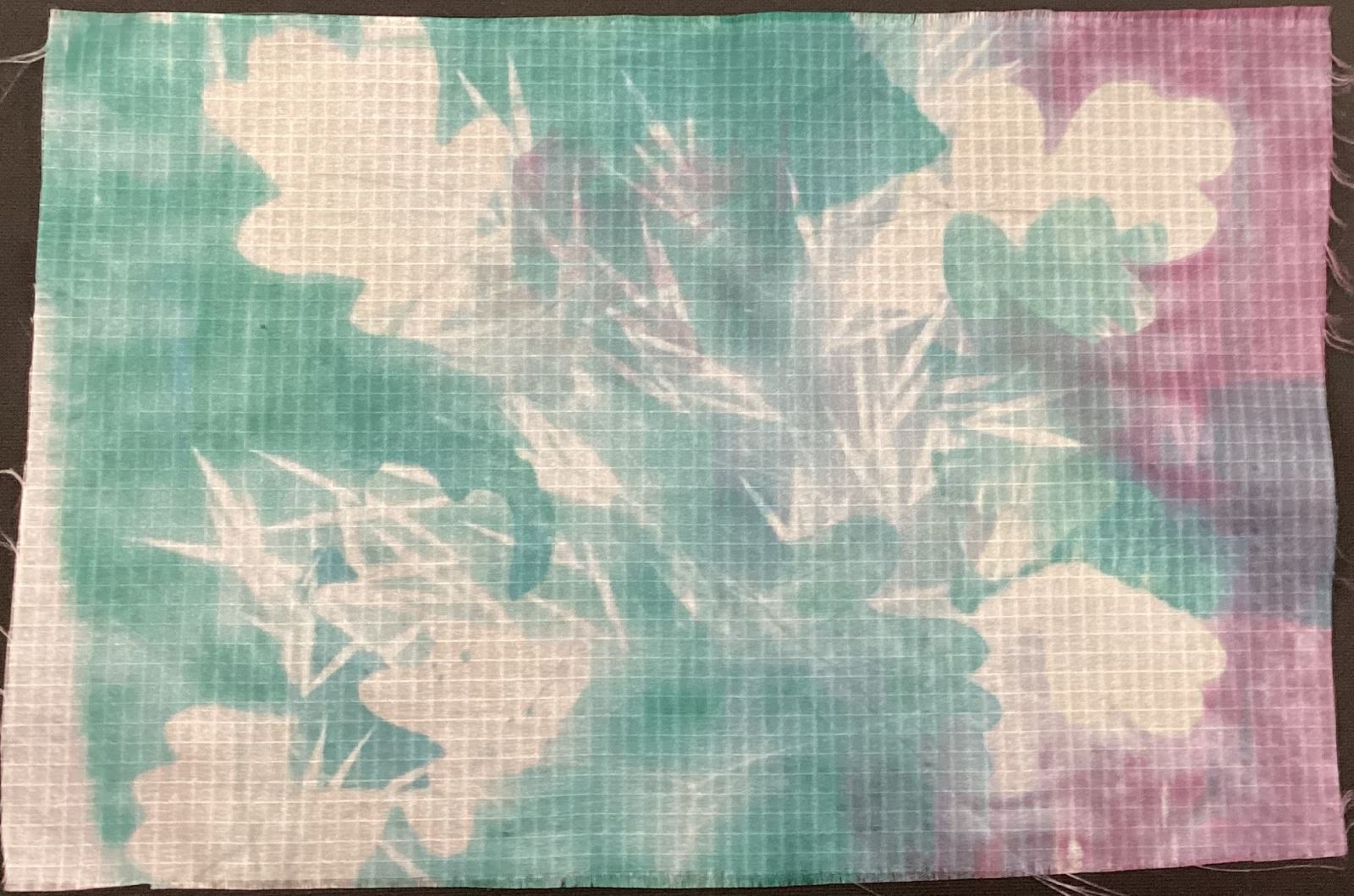 white leaves on green and red fabric