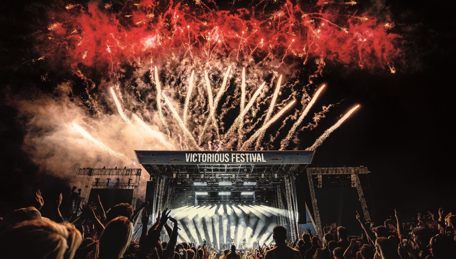 Red fireworks pop over the Common Stage at Victorious Festival