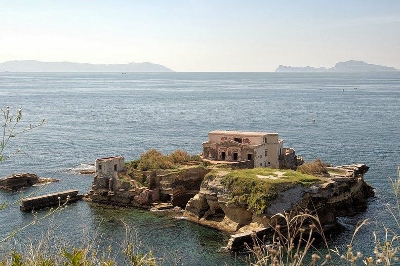 villa on a little island surrounded by water