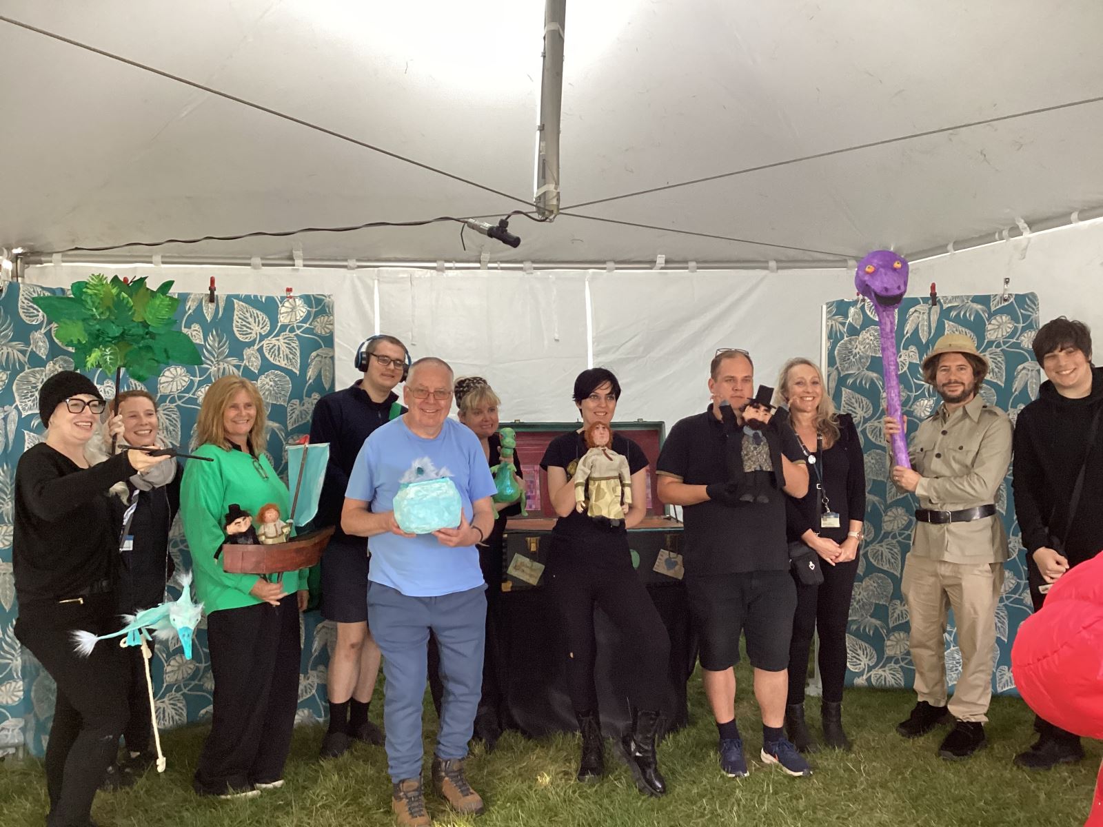 A group shot of all of the performers and staff and their puppets